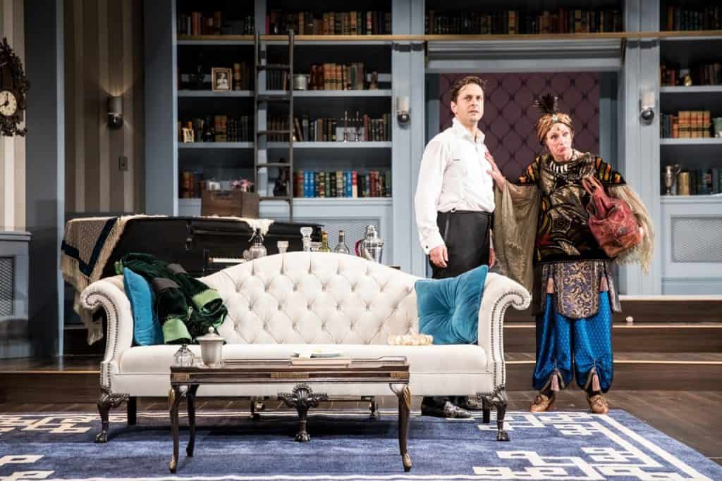 Quinn Mattfeld (Charles Condomine) and Sally Wingert (Madame Arcati) in the Guthrie Theater’s production of Blithe Spirit by Noël Coward, directed by David Ivers. Scenic design by Jo Winiarski, costume design by Meg Neville, lighting design by Xavier Pierce, sound design by Scott W. Edwards. Photo by Dan Norman.